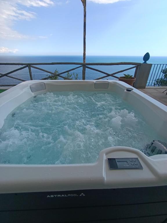 a jacuzzi tub sitting on top of a balcony at Villa Gea in Praiano
