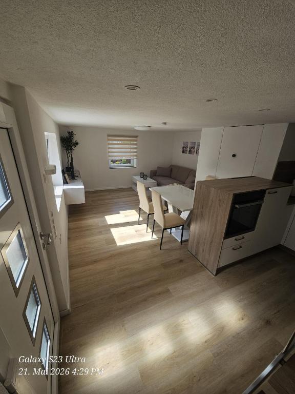 a kitchen and living room with a table and chairs at Schneiders Apartment Style House in Trunkelsberg