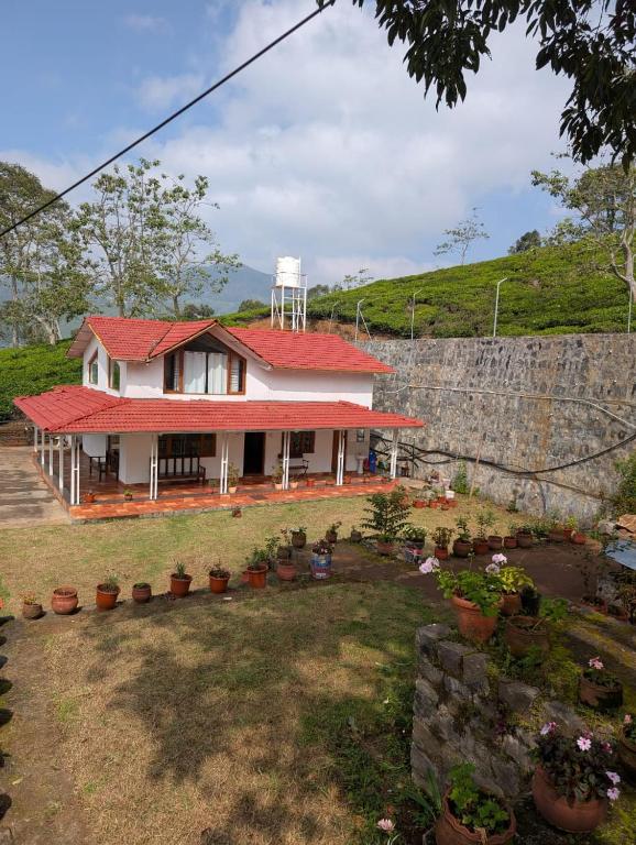 a house with a water tower on top of it at The Attic at Infinity Valley in Kotagiri