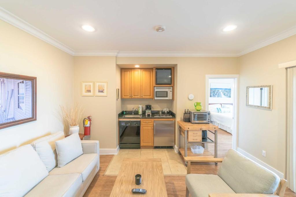 a living room with a couch and a kitchen at The Cliffside Resort Condominiums in Greenport