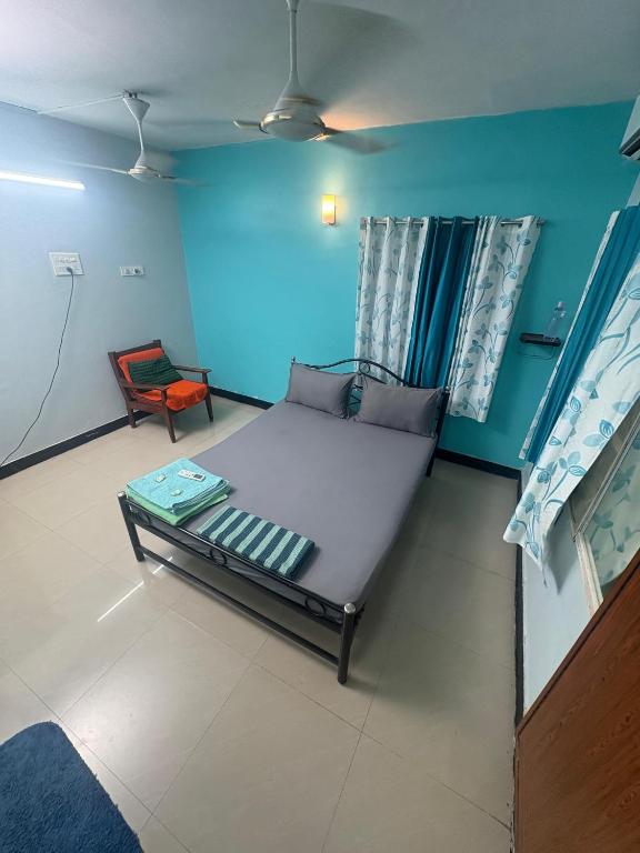 a small room with a bed and a chair at Explore Inn T-Nagar in Chennai
