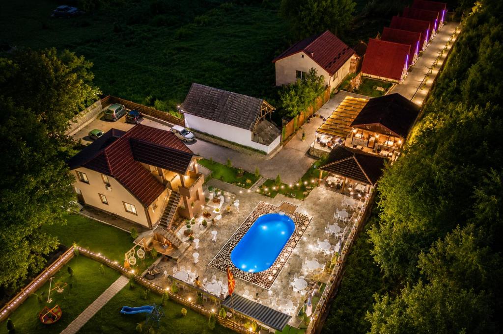 an overhead view of a backyard with a pool with lights at Bate Bole Mountain Villa in Elshani