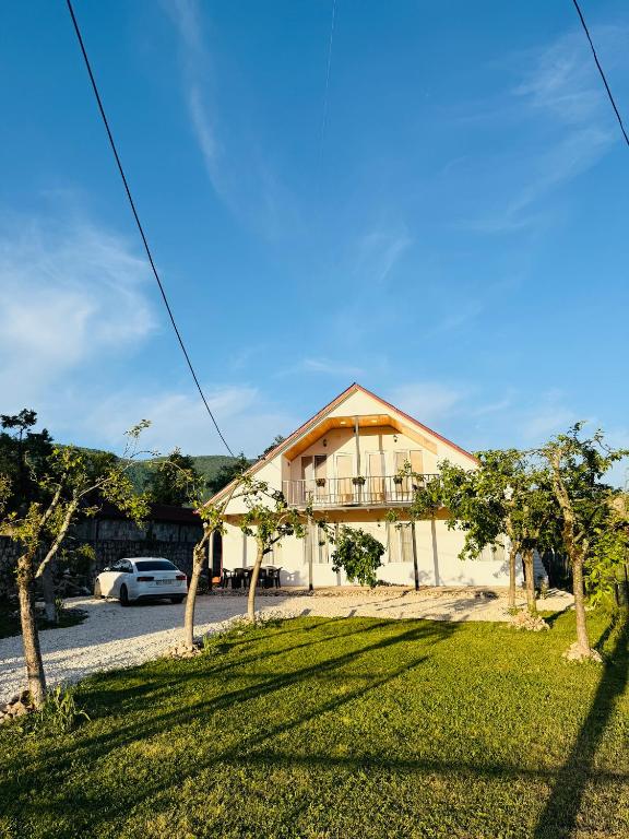 a house with a lawn in front of it at Loreta's Canyon Farmhouse in Martvili