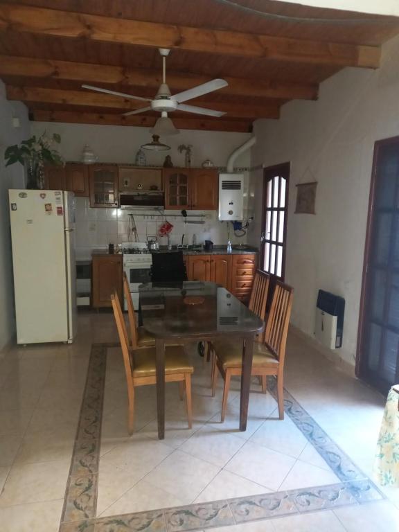 a kitchen with a table and chairs and a refrigerator at Casa tranquila y segura in Santa Fe