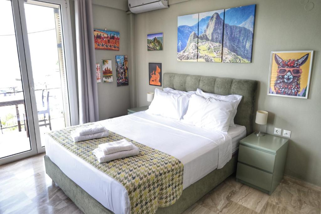 a bedroom with a large bed with white sheets at Stella Di Mare Pylos in Pylos