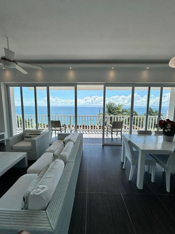 a living room with couches and a view of the ocean at Vista Mare Samaná in Punta Balandra