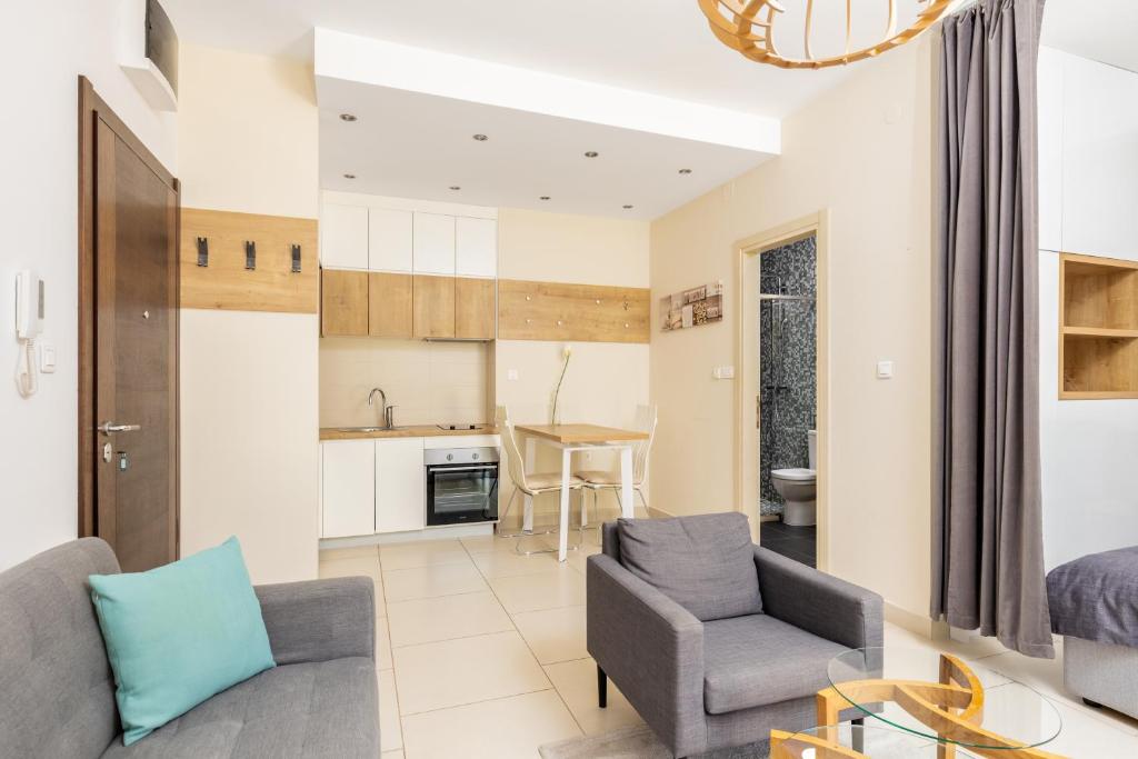 a living room with a couch and two chairs at Lavender Bay E2-1-studio apartment in Donji Morinj
