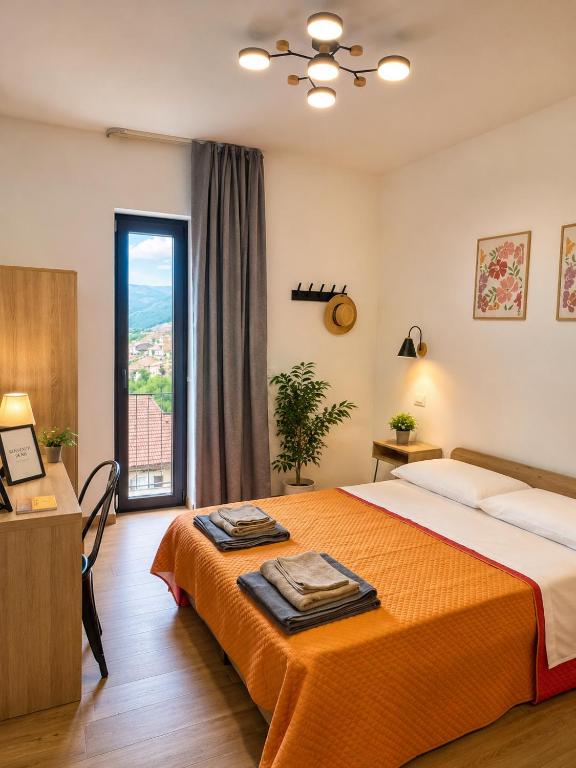 a bedroom with a bed and a large window at B&B La Casetta di Cecè in Celano
