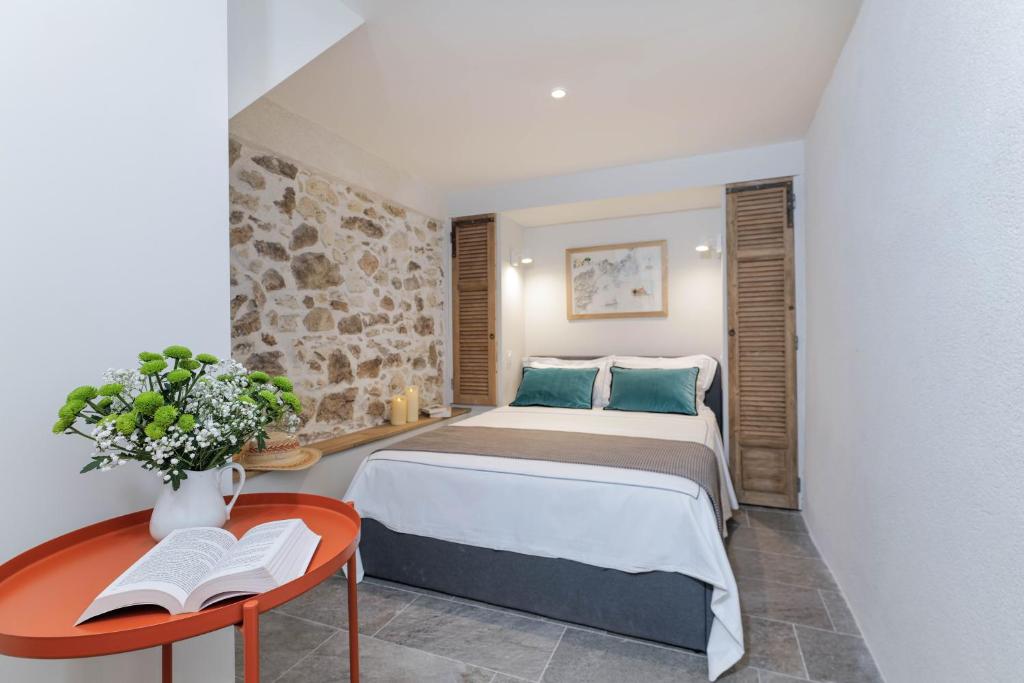 a bedroom with a bed and a table with a book at Maison entière à 100m de la mer in Antibes