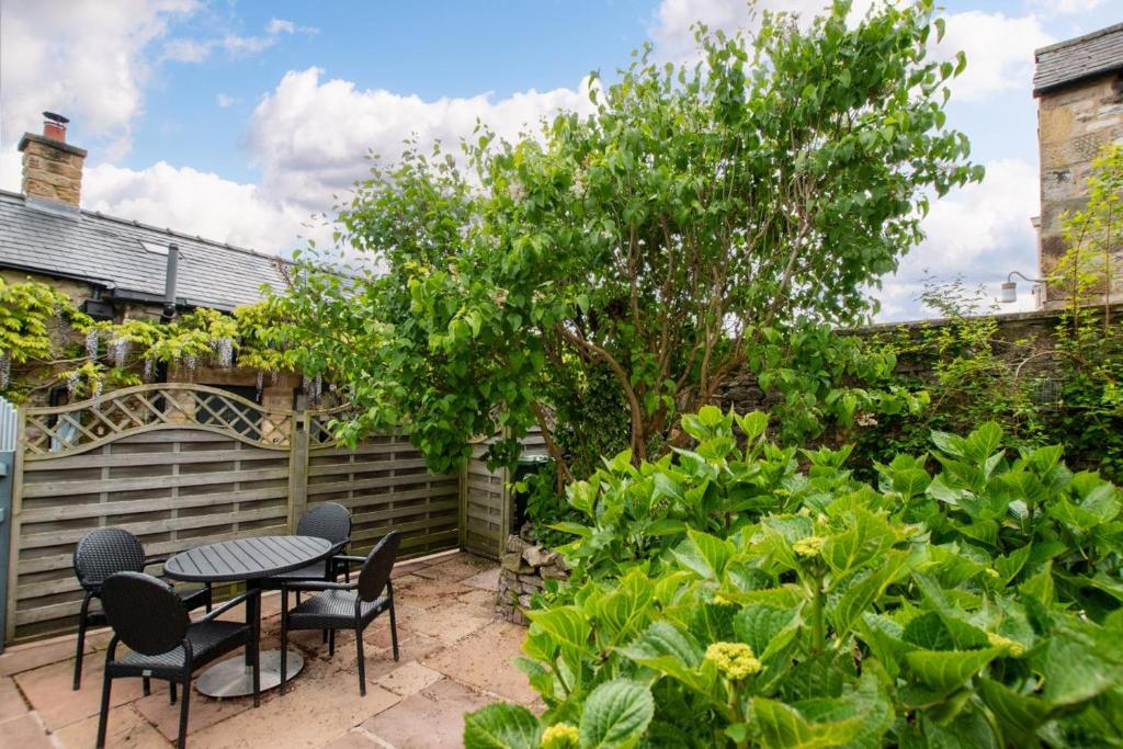 a patio with a table and chairs in a garden at 2 Bed in Bakewell oc-91038 in Bakewell