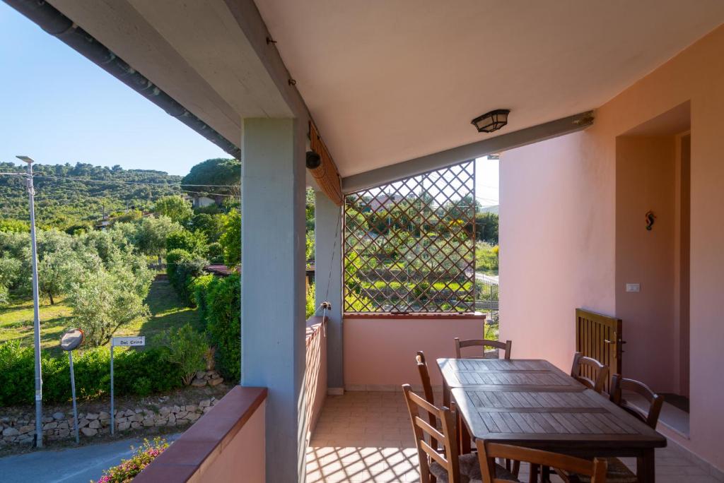 a balcony with a table and chairs and a view at Passeggiata Alla Spiaggia in Campo nell'Elba