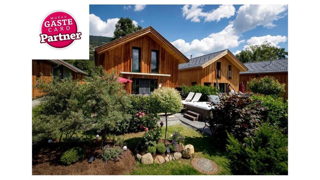 a large house with a garden in front of it at Luxury Chalet Kreischberg 11a in Sankt Lorenzen ob Murau