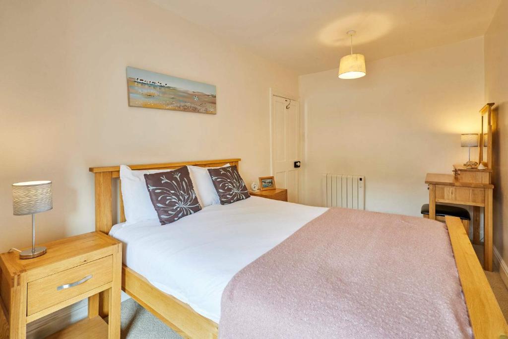 a bedroom with a large bed and a fireplace at Host & Stay - The Beach in Filey
