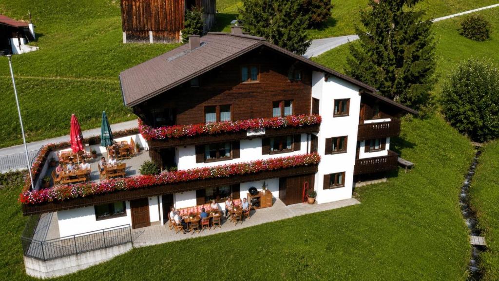 a large building with a table and chairs in front of it at Alpinchalet Zigjam in Gaschurn