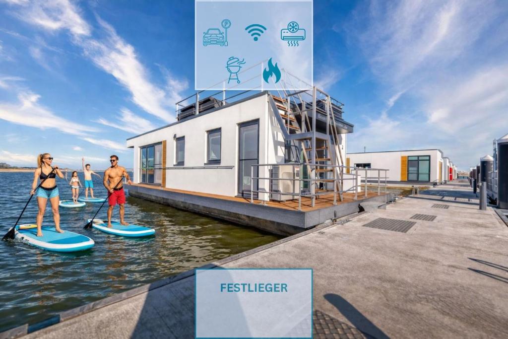 a group of people on paddle boards in the water at Floatinghouse Sunday in Ribnitz-Damgarten