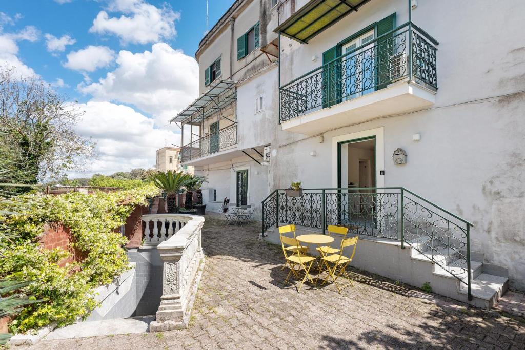 a balcony of a building with chairs and a table at La Casa Del Bosco - Two floors home in Naples