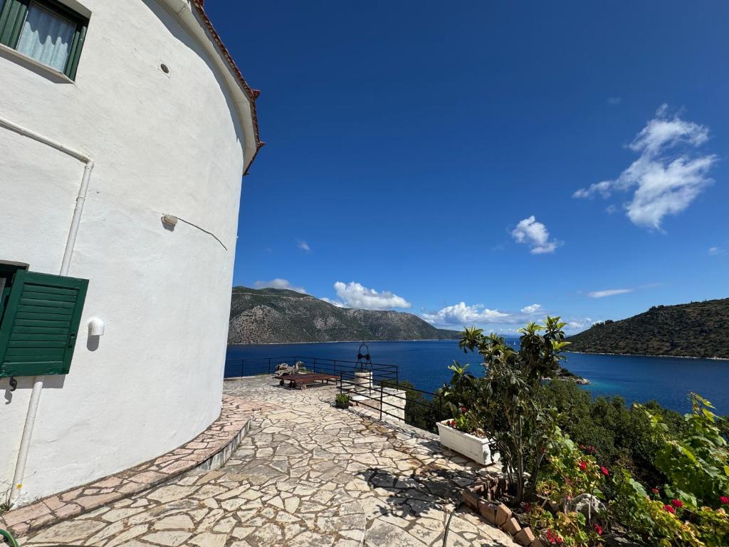 a view from the side of a building overlooking the water at Razos Windmill in Vathi