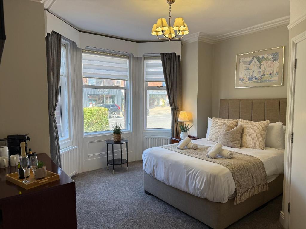 a bedroom with a large bed and a window at All Seasons Guesthouse in Belfast