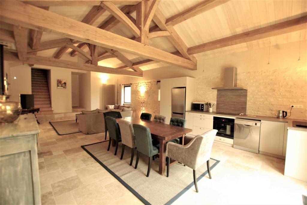 a kitchen and dining room with a table and chairs at gîtes du Cheylard in Les Farges