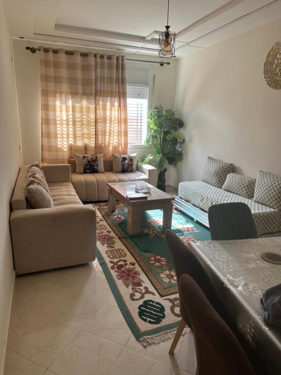 a living room with a couch and a table at Appartement Berkane in Berkane