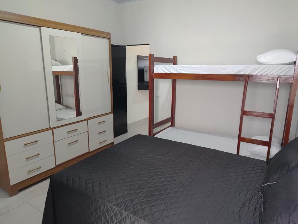 a bedroom with two bunk beds and a mirror at Espaço Aconchegante e Moderno in Primavera do Leste