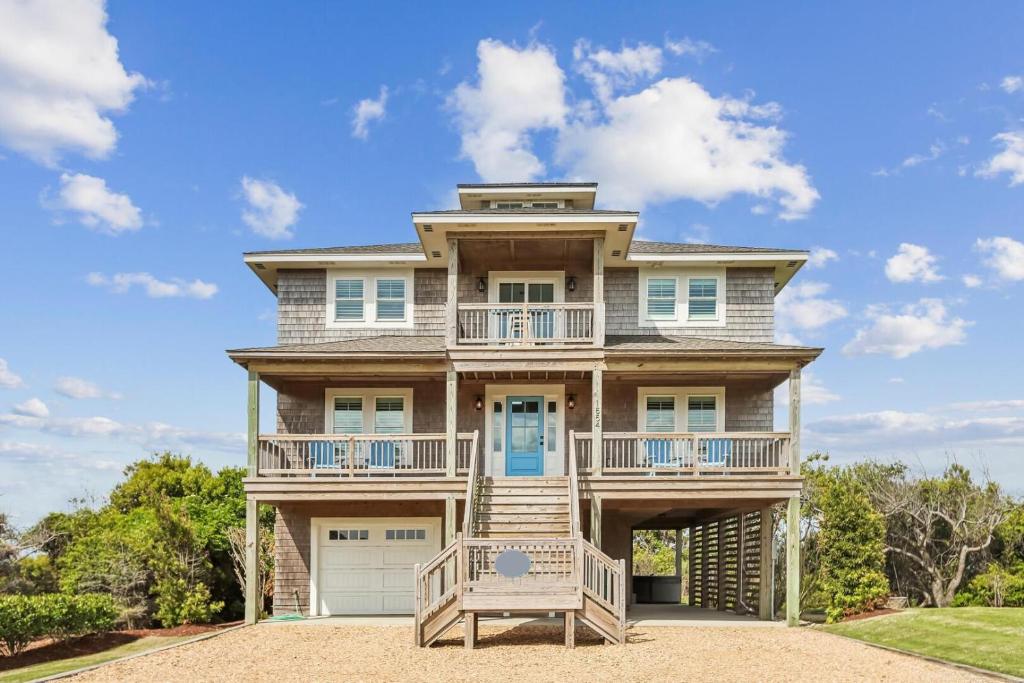 a large house with a porch and a balcony at Knot for Sail in Duck