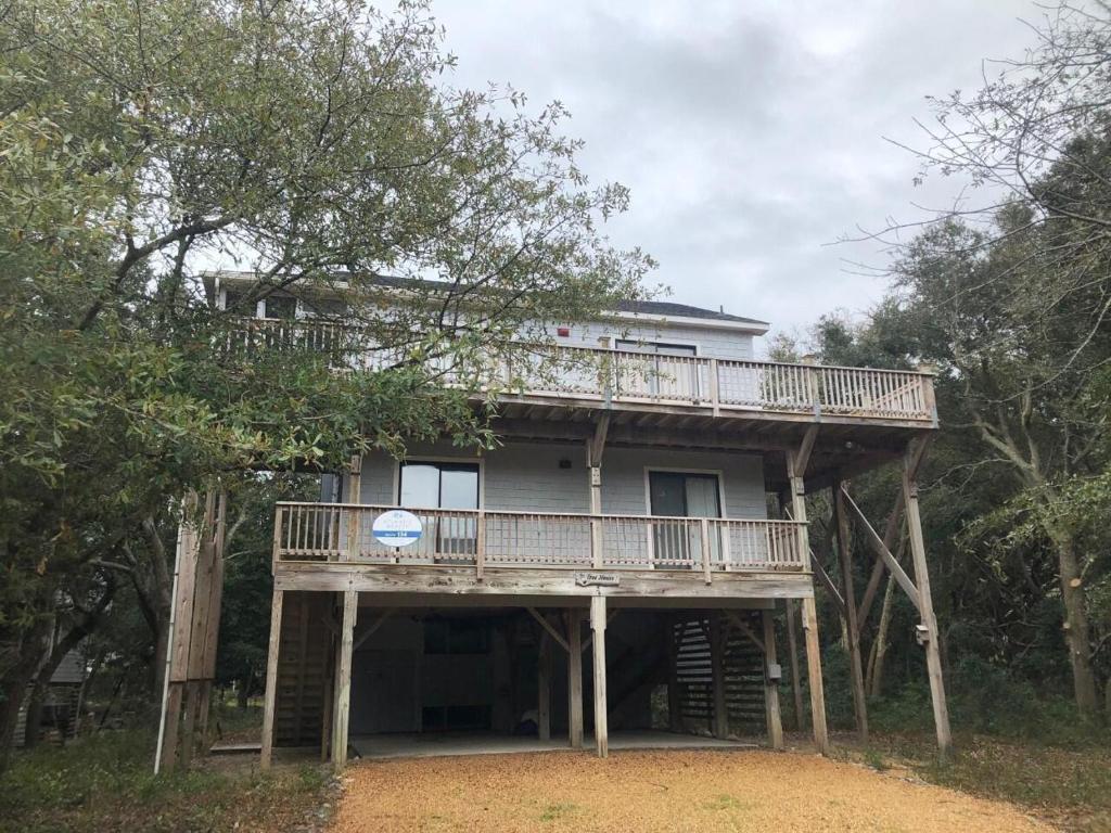 a large house with a deck on top of trees at The Tree House in Duck