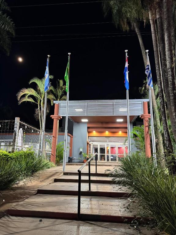 a building with flags in front of it at night at La Mision Posadas in Posadas