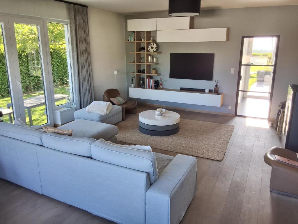 a living room with a couch and a tv at Fabiche in Verviers