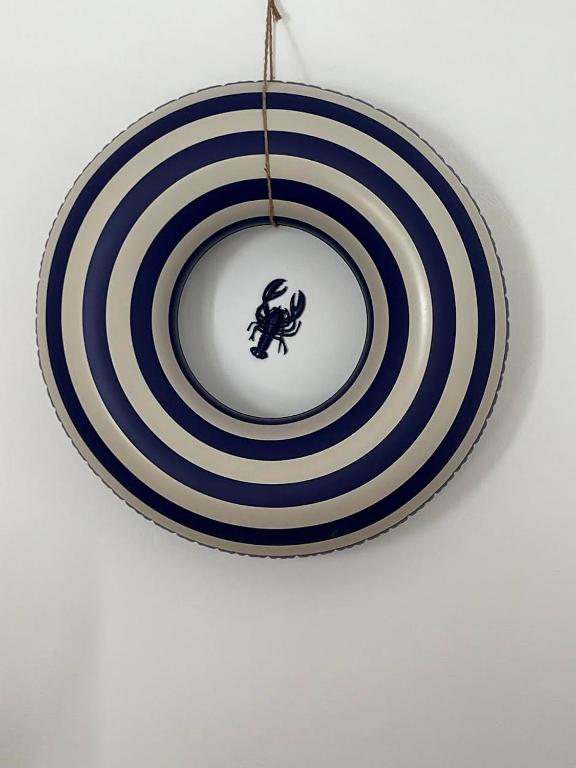 a blue and white plate hanging from a ceiling at ecrin mogador in Aït Sidi Saïd