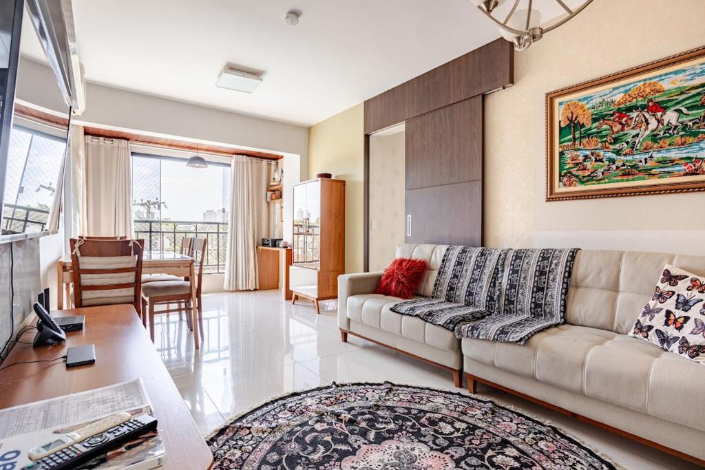 a living room with a couch and a table at Apto com conforto que você precisa. in Goiânia