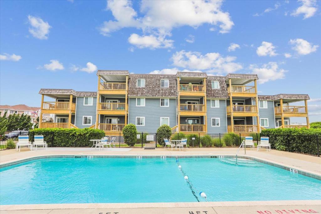 a large apartment building with a large swimming pool at Duck Legacy Unit 2E in Duck