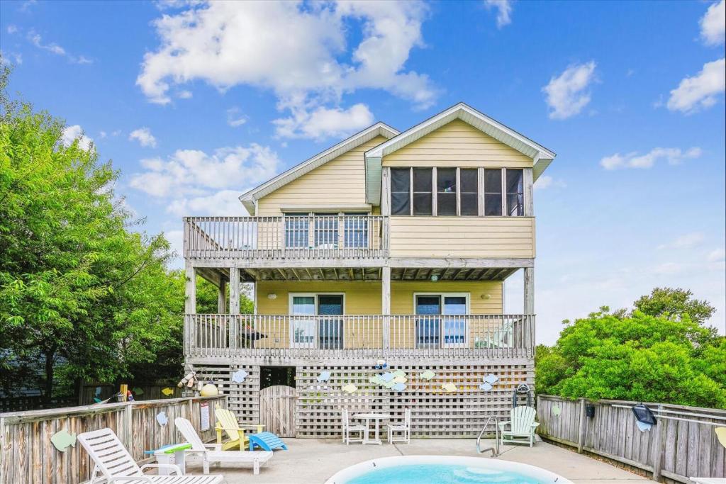 a house with a balcony and a pool at Duck Views in Duck