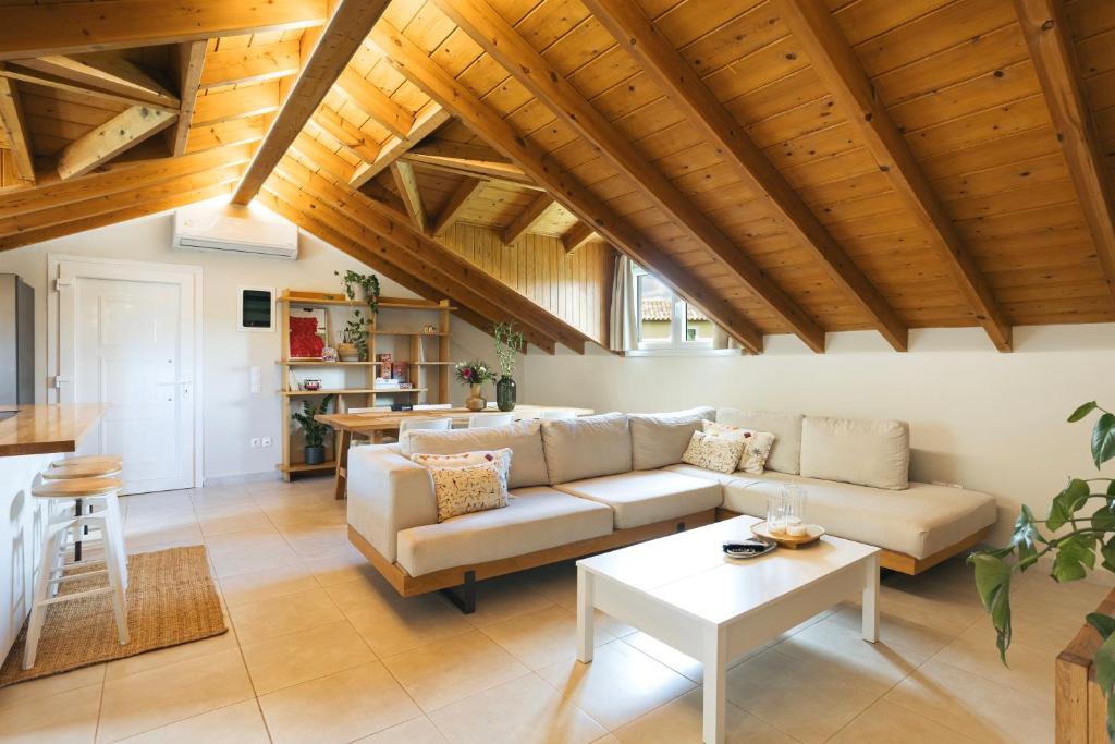 a living room with a couch and a table at The Hidden Attique in Corfu
