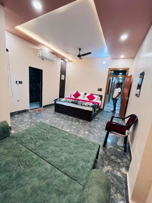a living room with a bed and a chair at Awadh kunj palace in Ayodhya