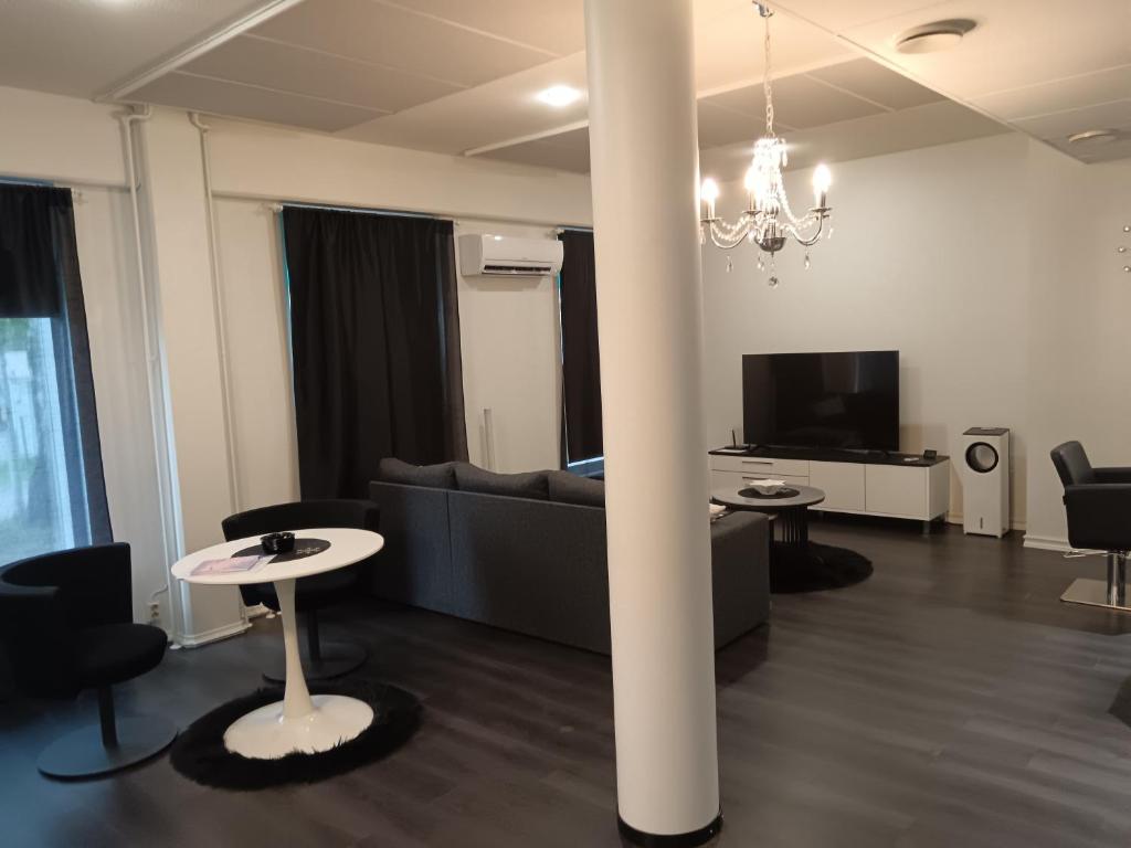 a living room with a couch and a table at Salon Harlekiini in Lieksa