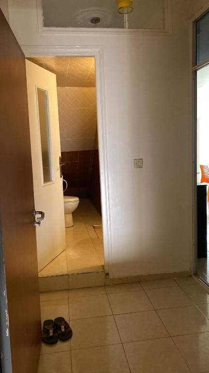 an open door to a bathroom with a toilet at Cozy Flat in Tan-Tan in Tan-Tan