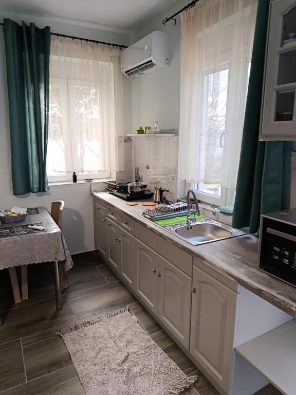 a kitchen with a sink and a counter top at Liana's house 2 in Perama