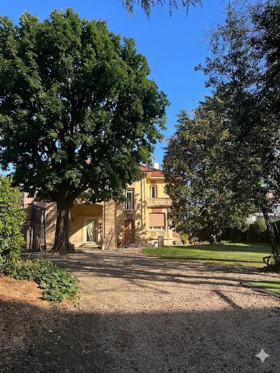 a large house with a tree in front of it at Maison Martina in Rivoli