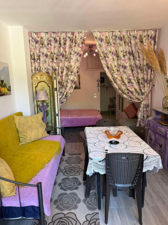 a living room with a couch and a table at liana house 3 in Skála Loutrón