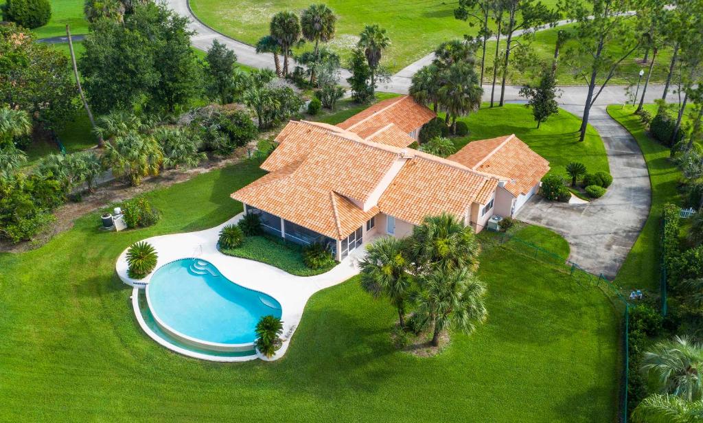 an aerial view of a house with a swimming pool at SWISS 30 - Golf Course in Clermont