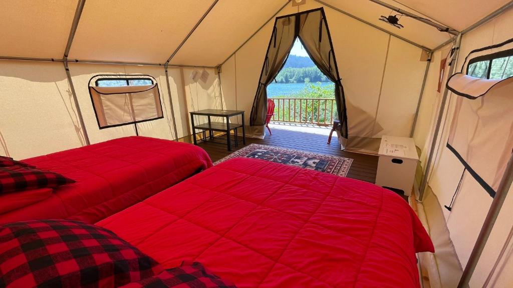 a tent with two beds and a table in it at Ruby Glamping tent - tent site #9 in Klamath