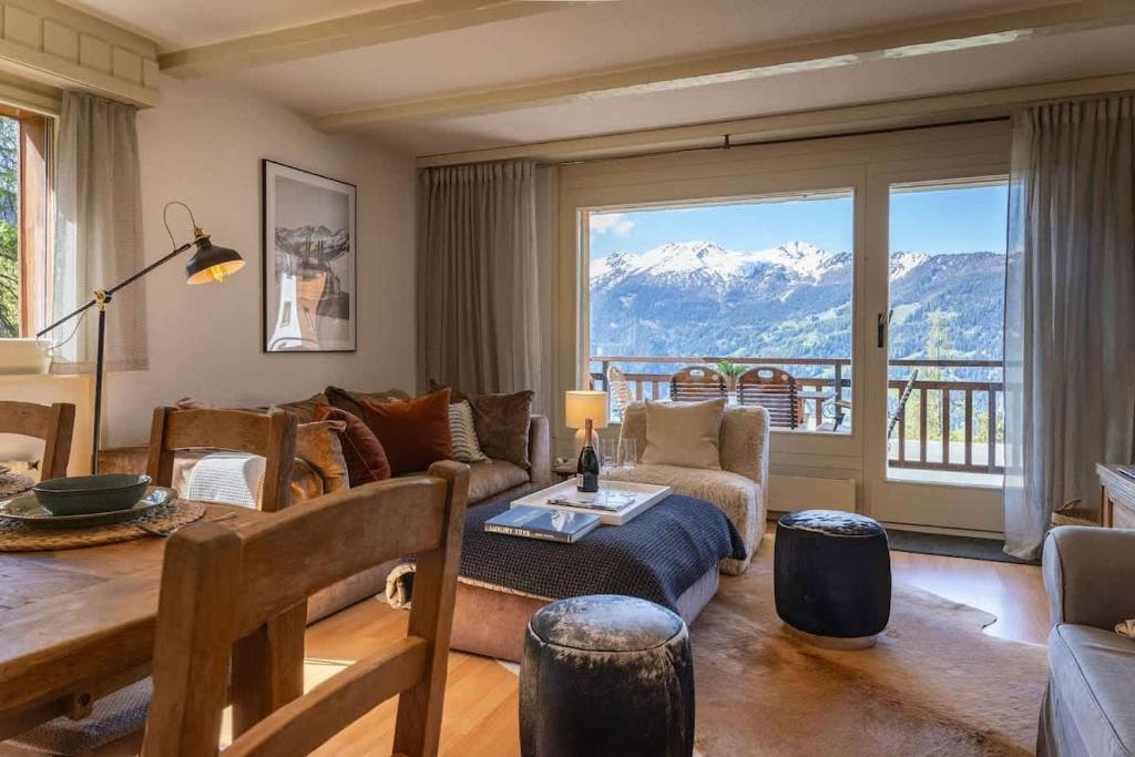 a living room with a view of a mountain at 3BR Central Pool Sauna Gym & Views in Verbier