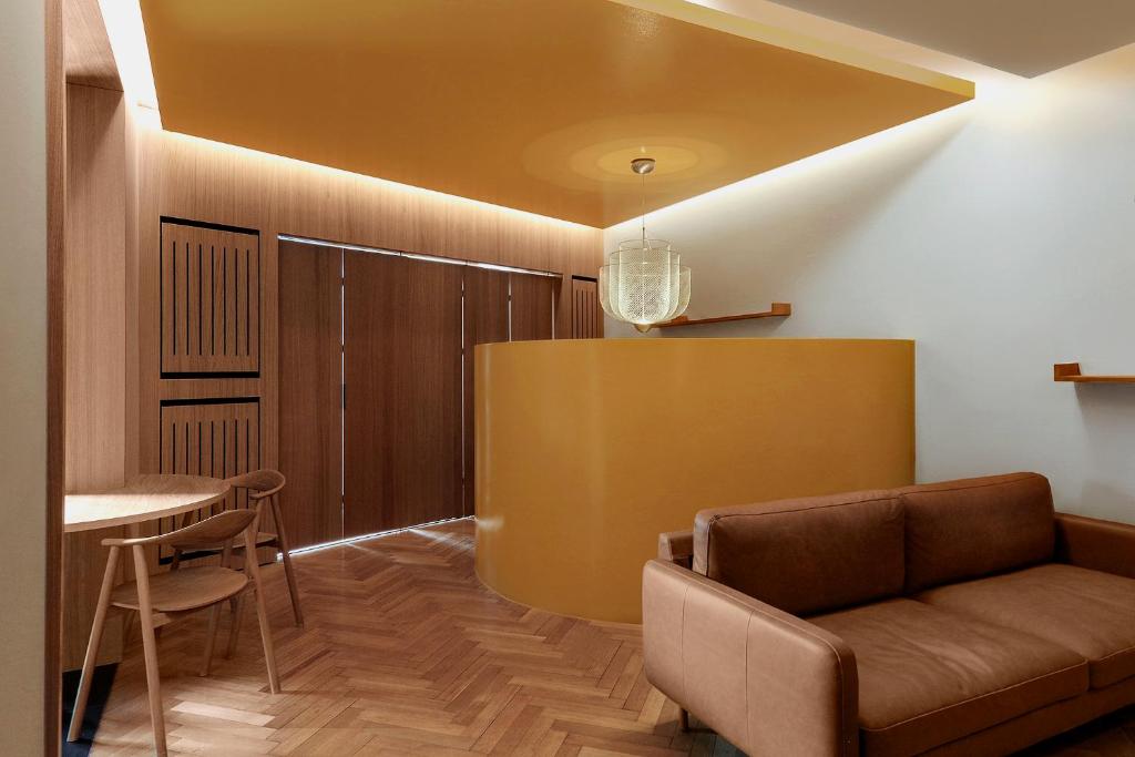a living room with a couch and a table at Woodline Suite in Luxembourg