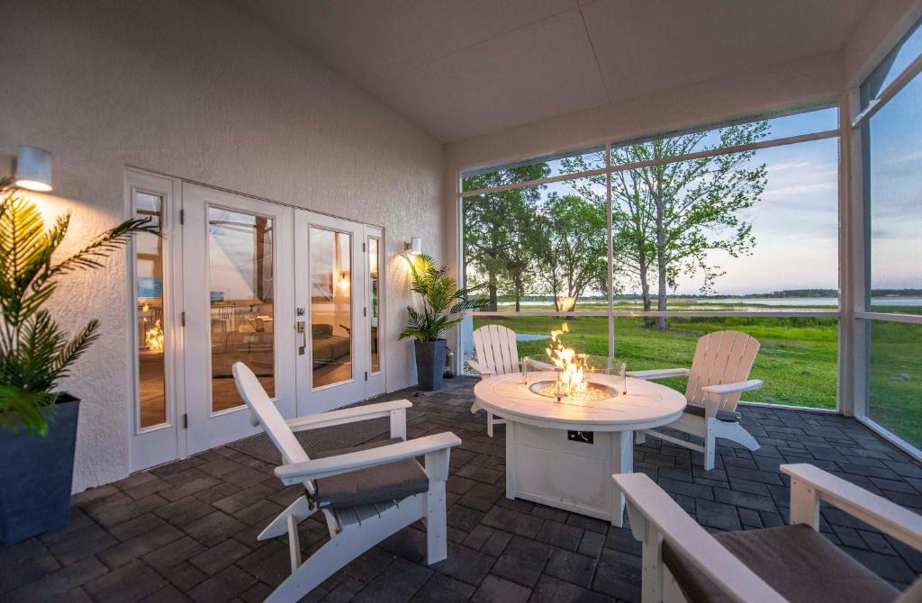 a patio with a table and chairs and windows at Sumner Lake House 3B in Clermont