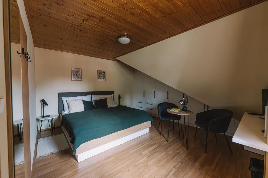 a bedroom with a bed and a table and chairs at Apartman Susilova Slavkov in Slavkov u Brna