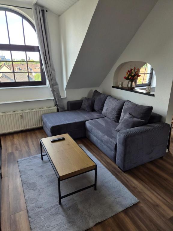 a living room with a couch and a coffee table at Pottblick Oberhausen in Oberhausen
