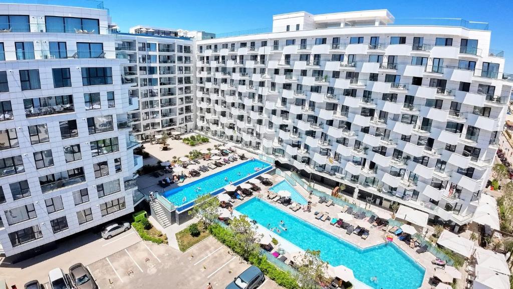 an aerial view of a large apartment complex with a swimming pool at INFINITY Sea View Luxury SUITE in Mamaia Sat/Năvodari