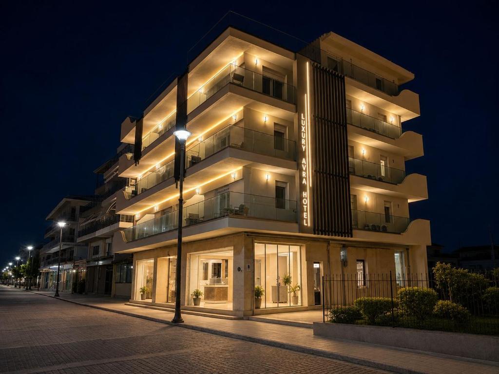 a building at night with lights on at Hotel Avra in Perea
