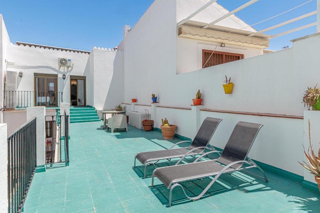 a patio with two chairs on a house at Marbella Village in Marbella